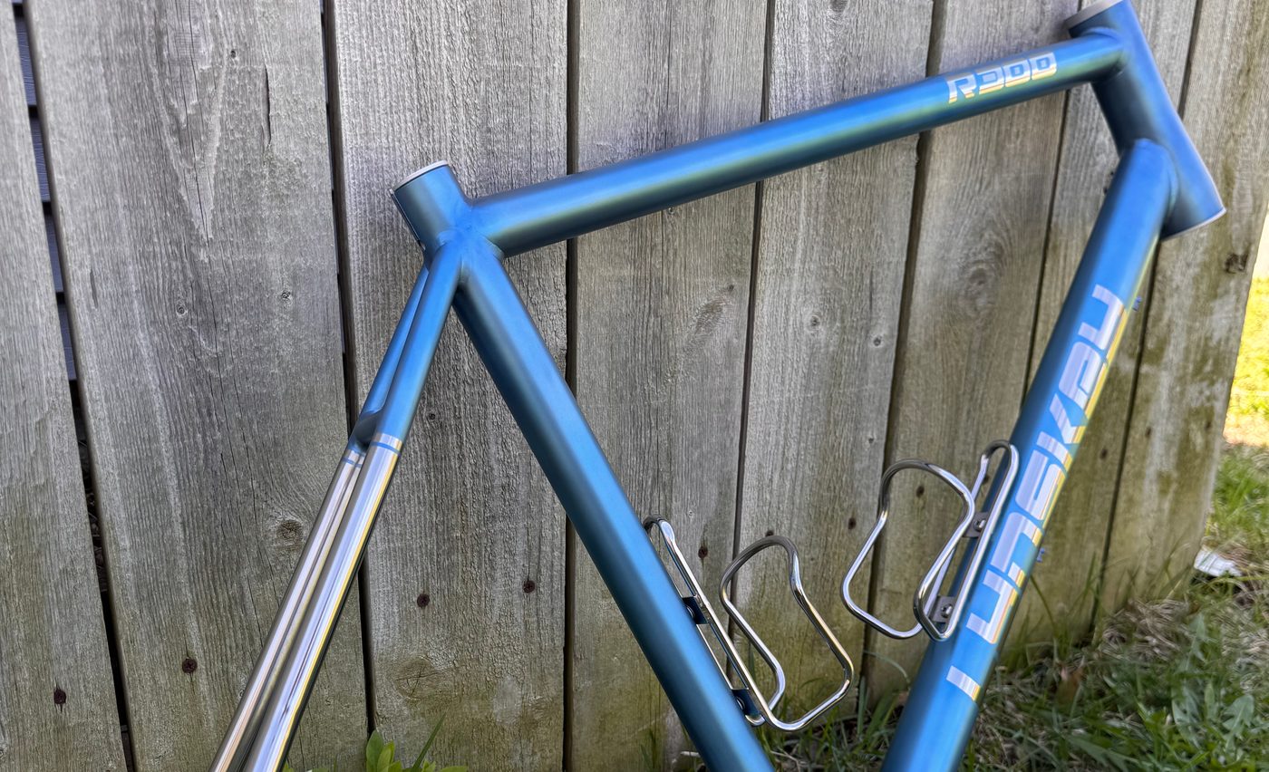 Lynskey titanium frame anodized in a blue fade against raw polished stays